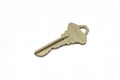 A brass house key isolated on a white background Royalty Free Stock Photo