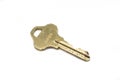 A brass house key isolated on a white background Royalty Free Stock Photo