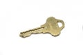 A brass house key isolated on a white background Royalty Free Stock Photo