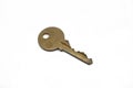 A brass house key isolated on a white background Royalty Free Stock Photo