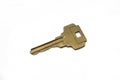 A brass house key isolated on a white background Royalty Free Stock Photo