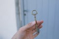 Old vintage brass door Key in mans hand Royalty Free Stock Photo