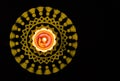 Brass lamp and yellow rangoli on black background with copy space. festival of lights Royalty Free Stock Photo
