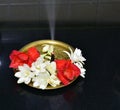 Brass metal plate decorated with jasmine flowers and aroma incense