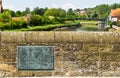 Brass name plaque on side of historic Arundel Bridge