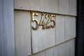 Brass number 5425 on an exterior wall