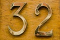 Brass number thirty two on wall Royalty Free Stock Photo