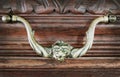 Brass old handle in vintage style on brown wooden drawer Royalty Free Stock Photo