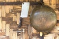 Brass pan and chopping knife hanging on the woven bamboo wall