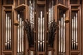 Brass pipes of organ at wooden wall in light catholic church Royalty Free Stock Photo