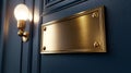 Brass plaque on blue wall with light bulb, sleek and elegant decor. Royalty Free Stock Photo