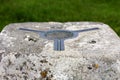 The brass plate used as a mounting point for a theodolite on top of a concrete British Ordnance Survey triangulation point, or Tri Royalty Free Stock Photo