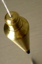 Brass plumb bob hanging