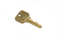 A brass security door key isolated on a white background Royalty Free Stock Photo