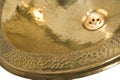 Detail of yellow brass round sink. Golden sink in retro style. Antique sink for home. Macro shooting. Royalty Free Stock Photo