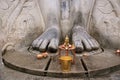 Brass statue infront of a gigiantic monolithic statue of Bahubali, also known as Gomateshwara, Vindhyagiri Hill, Shravanbelgola