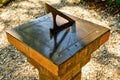 An old brass sundial in a garden setting