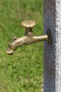 Brass tap on stone pillar