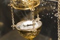 Brass thurible liturgy censer with burning incense in it Royalty Free Stock Photo