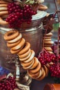 Brass vintage samovar, a bundle of bagels, red berries as a symbol of Russian hospitality Royalty Free Stock Photo