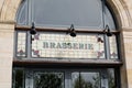 Brasserie restaurant text sign paint on wall facade french building city street