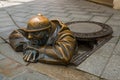 BRATISLAVA, SLOVAKIA: Bronze sculpture of plumber in Bratislava. Statue Mr. Cumil. The Watcher- or Man at work Royalty Free Stock Photo