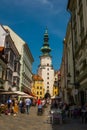 Bratislava, Slovakia: City street daily view of the historical buildings, people and the famous St. Michael`s Gate and Tower in