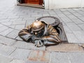 Bronze sculpture of a man watching passersby from a manhole Royalty Free Stock Photo