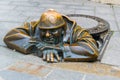 BRATISLAVA, SLOVAKIA, MAY 28, 2016: Cumil (The Watcher) statue of man peeking out from under a manhole cover in Royalty Free Stock Photo