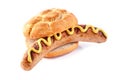 Bratwurst in a crusty bread bun with yellow mustard