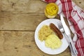 Bratwurst with sauerkraut mashed potatoes and mustard on a rusti Royalty Free Stock Photo
