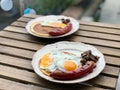 Bratwurst Sausage German Breakfast with Pancake, Fried Eggs, Crispy Bacon and Mushrooms. Royalty Free Stock Photo