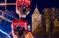 Braunschweig cathedral at night with a part of the Ferris wheel from the Christmas market in the foreground, intended motion blur Royalty Free Stock Photo