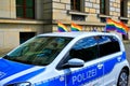 Police car decorated with rainbow flags while driving at CSD