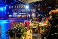 Braunschweig, Germany, December 1, 2020: Colorfully illuminated Kohlmarkt in Braunschweig with the displays of a flower store in t