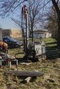Small drilling rig with caterpillar drive performing drilling work for soil exploration on a lawn area