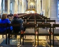 Braunschweig, Germany, November 4., 2018: Older couple sitting at the edge of the last row on the chairs of a Christian church