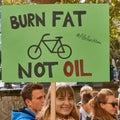 Beautiful young girl at the Friday for future demonstration with a poster with the inscription burn fat not oil
