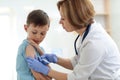 Brave boy receiving injection or vaccine with a smile