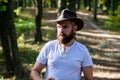 Brave cowboy. camping and hiking. mature male with brutal look. Bearded man in cowboy hat walk in park outdoor. man Royalty Free Stock Photo