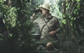 Explorer with binoculars in the jungle Royalty Free Stock Photo