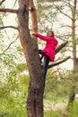 Brave girl climbs high on a tree