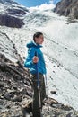 Brave girl conquering mountain peaks of the Altai mountains. The majestic nature of the mountain peaks and lakes. Hiking