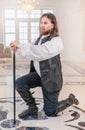 Brave man in medieval clothes with cane standing on knee Royalty Free Stock Photo