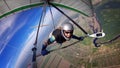 Brave hang glider pilot soar high over town and river.