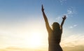 Brave happy young woman raising hands up in the air. Royalty Free Stock Photo