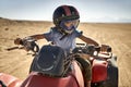 Kid in helmet and protect mask riding quad bike Royalty Free Stock Photo