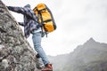Brave lifestyle climber with professional backpack climb to the rock