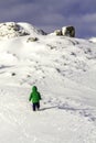 A brave little boy trying to climb a rock