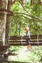 Brave little girl in the forest adventure park